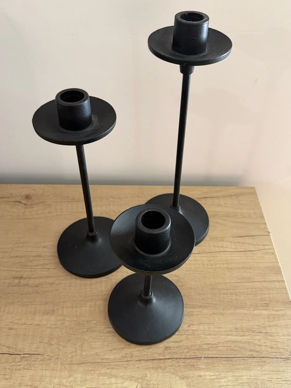 Set of three black metal taper candle holders